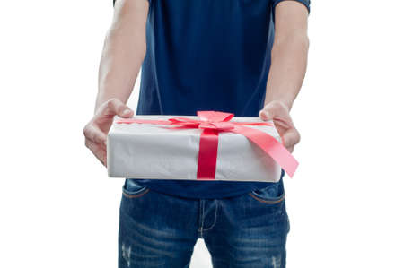 Man holding a gift box in a gesture of givingの写真素材