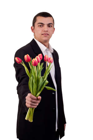 Young man offering tulip flowersの写真素材