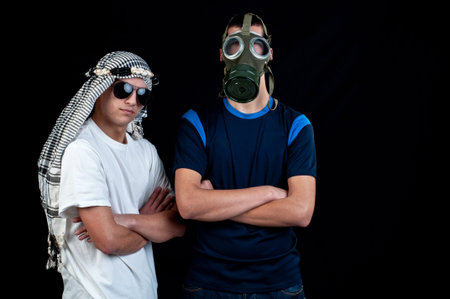 Young Arab with sunglasses and a young man with gas mask