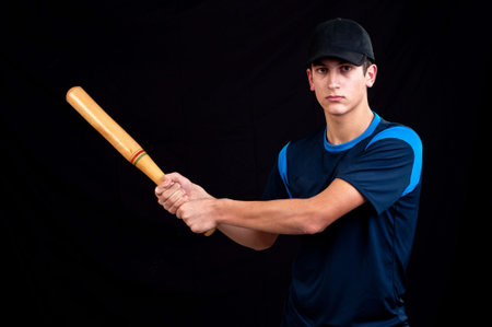 young man playing baseball for fun on black background