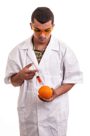 Scientist injecting GMO into orange, genetic modification of fresh fruitsの写真素材