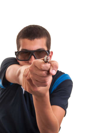 young man with 3d glasses is pointing a weapon at camera for funの写真素材