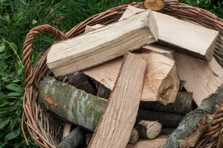 Closeup basket of cut logs fire wood, environmental conceptの写真素材