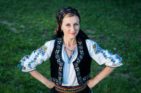 Young beautiful singer posing in traditional costume, romanian folkloreの写真素材