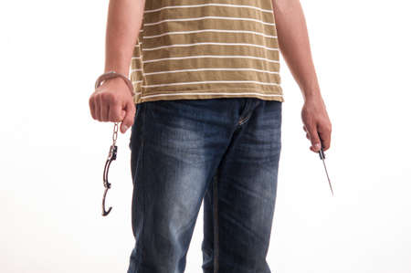 Close up of a man handcuffed with a knife in handの写真素材
