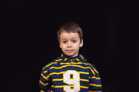 Cute little boy with a serious look, posingの写真素材