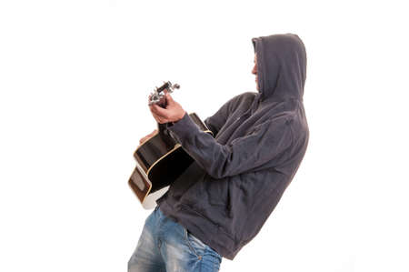 young musician in hoodie playing the guitar and danceの写真素材