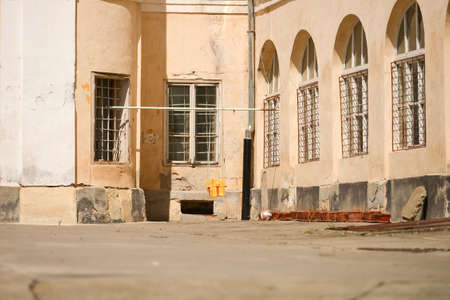 Empty plastic swings hanging in the yarf of a medieval castle in golden evening sunlightのeditorial素材