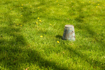 Spring gardening - overturned pot upside down in grass, copyspaceの写真素材