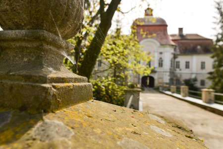 Close up of a spider web caught by a statue of a medieval castle in the backgroundのeditorial素材