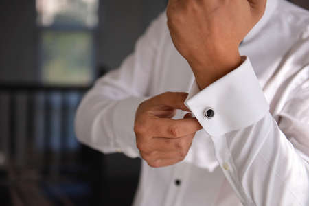 close up of a hand man how wears white shirt and cufflinkの写真素材