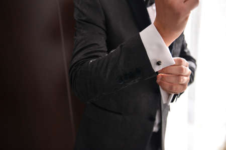 close up of a man who wears suit and white shirt and cufflinkの写真素材