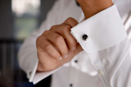 close up of a hand man how wears white shirt and cufflinkの写真素材