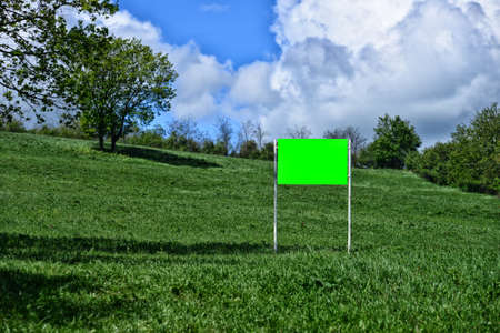 Big blank and green billboard in the nature. Copy spaceの写真素材