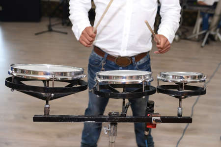 Drummer in action. Photo close up process play on a musical instrument at an eventの写真素材