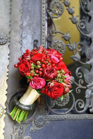Beautiful bridal bouquet lies on the door handleの写真素材