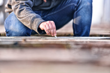 Hand of a young man extinguishing cigarette on a old bridge. Concept quit smoking. Selective focus