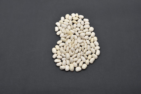 Large bean made from white beans on black background. Food vegan, vegetarian. Healthy food