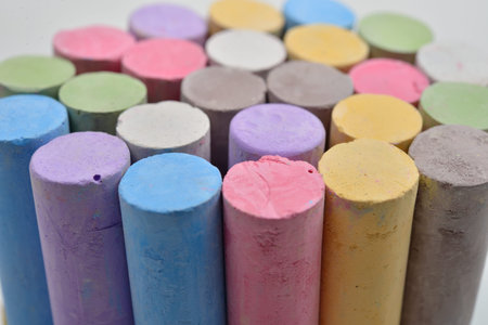 Macro picture of chalks in a variety of colors on a white background. Drawing rainbow. Back to...