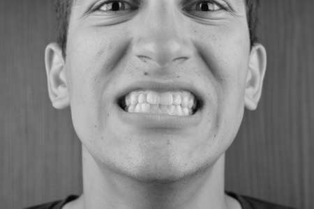 Detailed image of man showing his teeth. Dental health care. Hygiene. Dentistry. Black and whiteの写真素材