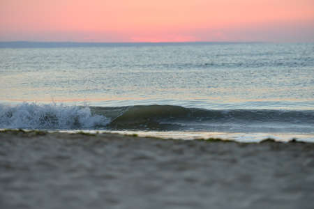 Early morning, the image of the sea before the sunrise. Calm waves, red sky. Landscapeの写真素材