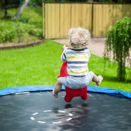 Funny little boy on trampolineの写真素材
