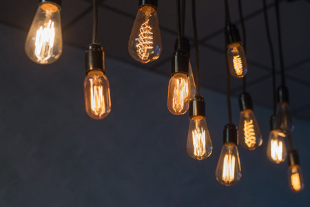 Decorative antique edison style light bulbs against brick wall background.