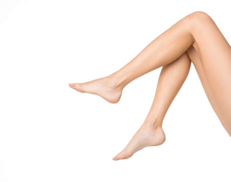 Long pretty woman legs isolated on whiteの写真素材