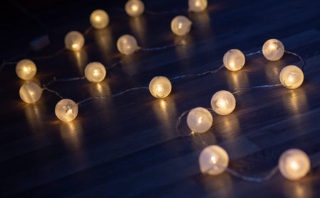 Glowing colorful Christmas lights on black background. New Year. Christmas. Decor. Garlandの写真素材