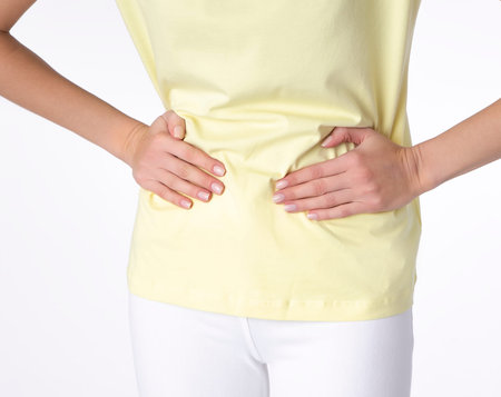 Young beautiful woman having painful stomachache on white background.Chronic gastritis. Abdomen...