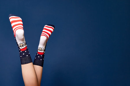 Woman leg in red grey christmas socks.の写真素材