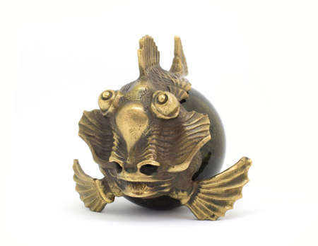 Bronze stone miniature antique fish isolated on white backgroundの写真素材