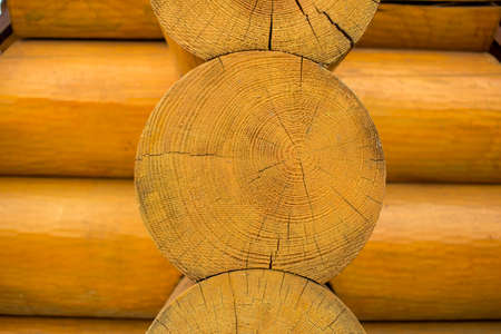 Round logs on wooden house closeup backgroundの写真素材