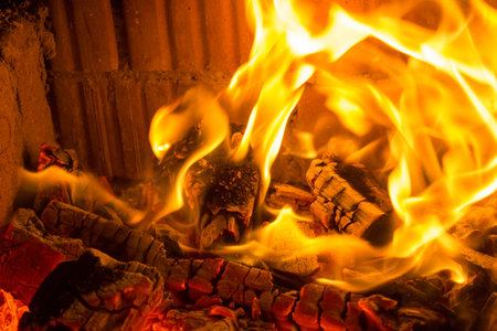 Burning red charcoal in the fireplace background
