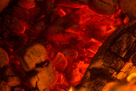 Glowing close-up charcoal hot pieces background texture