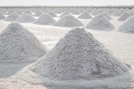 Sea salt pile pyramid made from evaporation of seawater andready for harvest in salt farm at...