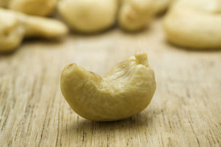Cashew nut closeup on a wooden surface の写真素材