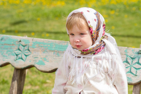 Little girl crying while sitting on the bench