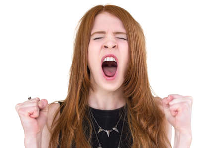 Girl screams with clenched fistsの写真素材