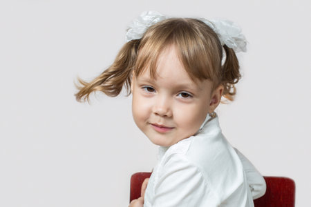 Little girl twists her head