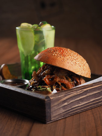 Perfect meat burger with fresh cold lemonade on the background of the tableの写真素材