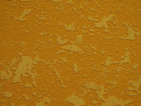 Yellow stucco texture. Abstract background and texture for design. Yellow textured surface with cracks close-upの写真素材