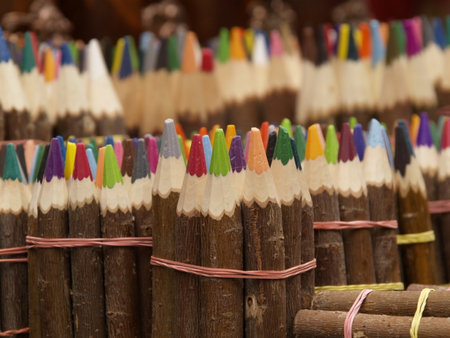 Collected sets of sharpened colored wooden pencils handmade on a market counter Colorful wooden pencils on display at a market in India.の写真素材