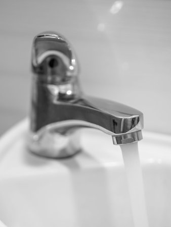 close up of a faucet in a bathroom. black and whiteの写真素材