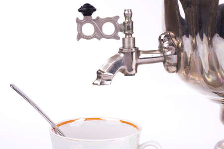 Closeup of traditional russian tea kettle faucet and teacupの写真素材