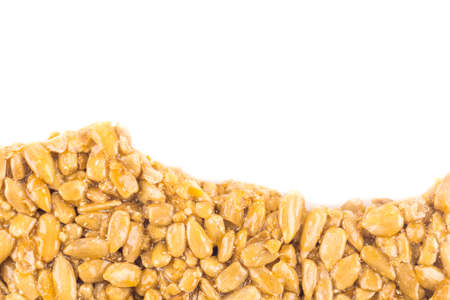Nuts-and-honey bar, oriental sweets from candied sunflower seeds isolated on whiteの写真素材
