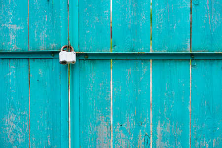 Closeup of wooden gates with padlockの写真素材