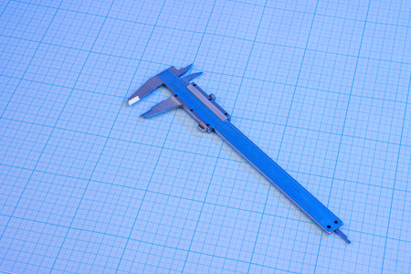 Vernier-caliper on graph paper under blue lightの写真素材