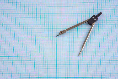 Compasses on graph paper backgroundの写真素材