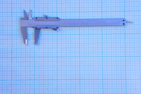 Vernier-caliper on graph paper under blue lightの写真素材